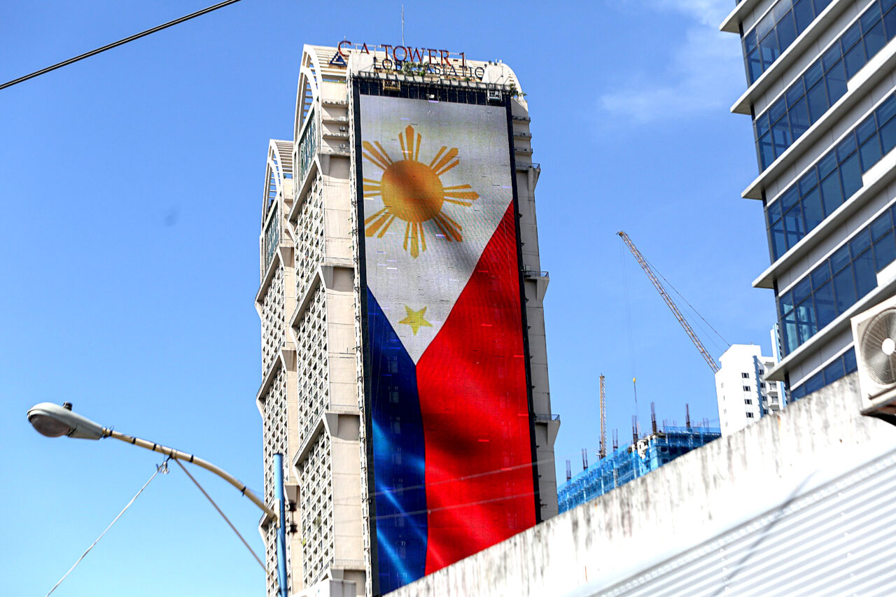 https://www.tripleiconsulting.com/wp-content/uploads/2023/10/philippines-flag-building-1280x853.jpg